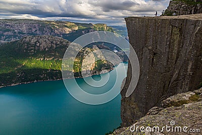 Preikestolen - landscape of tourists at the top of spectacular Pulpit Rock cliff and surrounding fjords, Norway Stock Photo