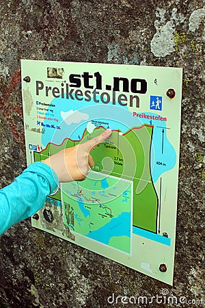 A woman pointing at sign in Preikestolen, Norway Editorial Stock Photo