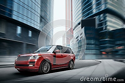 Premium car fast drive on road in the city at daytime Stock Photo