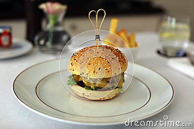 Premium hamburger with cheese lettuce and tomato exquisite meal, luxury meat unique cuisine in VIP gastronomy restaurant Stock Photo