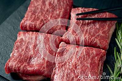 Premium raw Black Angus beef minute steak on Black wooden background. Slice wagyu Stock Photo