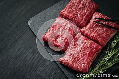 Premium raw Black Angus beef minute steak on Black wooden background. Slice wagyu Stock Photo