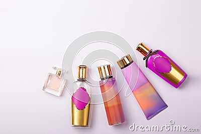 Premium skin care cosmetics and perfume on purple background. Stock Photo