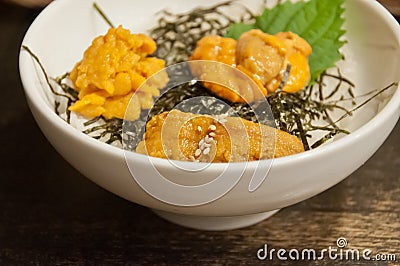 Premium supreme delicious fresh from the sea 3 types of uni sea urchin sashimi from Tokyo, Mexico, Canada on top of warm steamed Stock Photo