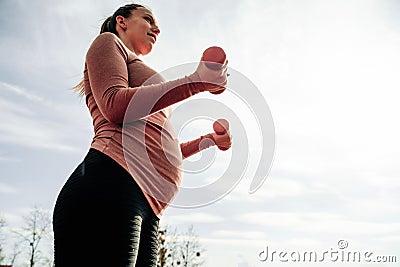 Prenatal exercises. Prenatal healthy fitness active fit gym outside. Pregnant woman training yoga sport exercise Stock Photo