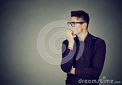 Preoccupied anxious man biting his fingernails Stock Photo