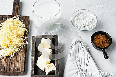 Preparation of bechamel cheese white sauce, on white stone background Stock Photo