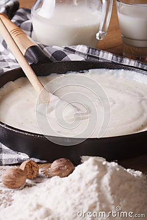 Preparation of bechamel sauce in a pan, vertical Stock Photo