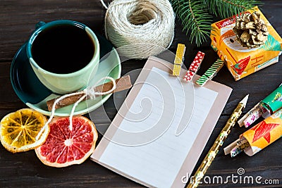 Notepad lays on the wooden background to make a list to do things or list of presents for friends and family. New year Stock Photo