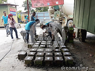 Preparation of concrete cube for concrete compression and strength test in the laboratory. Editorial Stock Photo