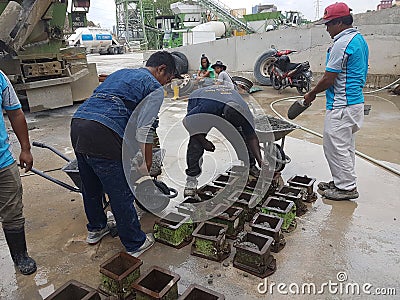 Preparation of concrete cube for concrete compression and strength test in the laboratory. Editorial Stock Photo