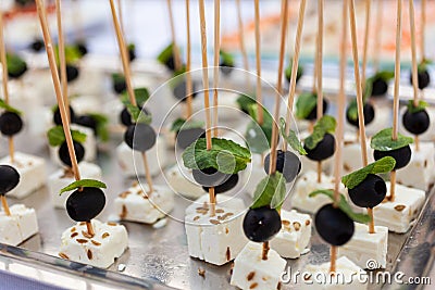 Appetizers with soft goat cheese with olives and mint leaves Stock Photo
