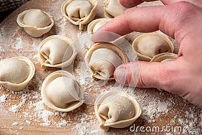 Preparation dumplings on wooden board. Stock Photo