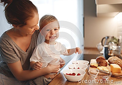 preparation of family breakfast. mother and baby son cook porridge in morning Stock Photo