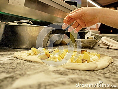 Preparation of an Italian pizza, with potatoes and mozzarella Stock Photo