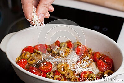 Preparation of mediterranean style baked fish with vegetables Stock Photo