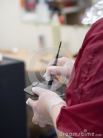 Preparation of a mixture for hair coloring. Stock Photo