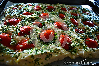 Preparation of raw dough for ciabattna with fresh pieces of red pardons, green dill and garlic. Stock Photo