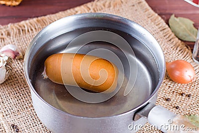 Preparation of sausages in a saucepan Stock Photo