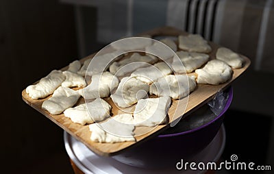 Preparation of traditional Kazakh pastries - baursaks. The cut pieces of dough are ready for frying. Stock Photo