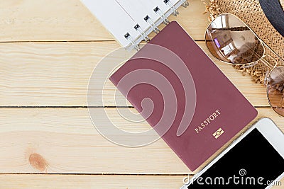 Preparation for Traveling concept, passport, smartphone, sunglasses, noted book, hat on a wooden background Stock Photo