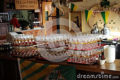 Prepared glasses with whiskey for irish coffee in a pub. Editorial Stock Photo