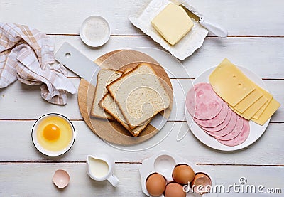 Prepared ingredients for making a hot croque madame sandwich on a white wooden background. Recipes for sandwiches, hot breakfasts Stock Photo