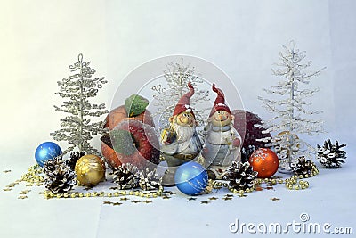 Two gnomes, apples, balls and fur-trees Stock Photo