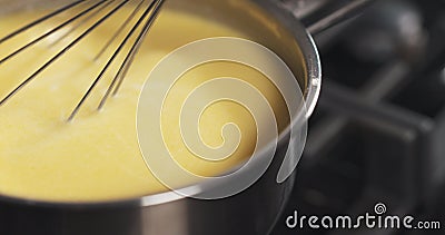 Preparing bechamel sauce milk mix Stock Photo