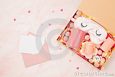 Preparing care package, seasonal gift box with tea cup, candles and sleeping mask. Personalized eco friendly basket for Stock Photo