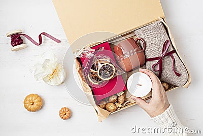 Preparing care package with warm socks, book, coffee cup, aroma spices Stock Photo