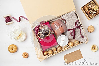 Preparing care package with warm socks, book, coffee cup, aroma spices Stock Photo