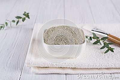 Preparing cosmetic mud mask with various skincare products. Dry clay powder in bowl. Natural cosmetics for home or salon spa treat Stock Photo