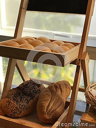 Image of breads, pastries, neatly arranged on baskets and shelves. Stock Photo