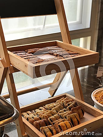 Image of breads, pastries, neatly arranged on baskets and shelves. Stock Photo