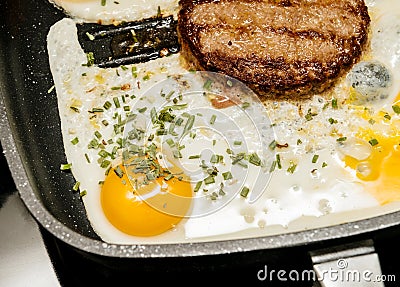 Preparing delicious burger with egg at home Stock Photo