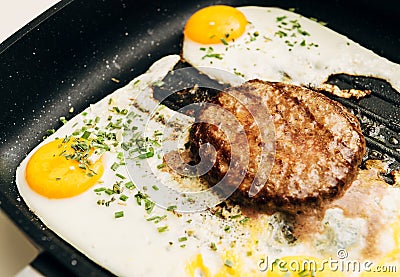 Preparing delicious burger with egg at home Stock Photo