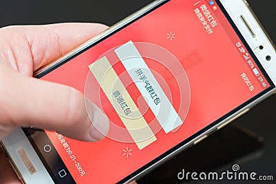 Preparing an electric red pocket on WeChat for Chinese new year of Rooster Editorial Stock Photo