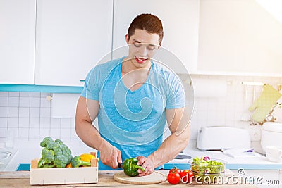 Preparing food cut vegetables young man healthy meal kitchen eat Stock Photo