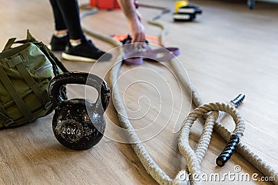 Preparing gym equipment for boot camp and work out. kettle bell, rope, sandbag in gym hall Stock Photo