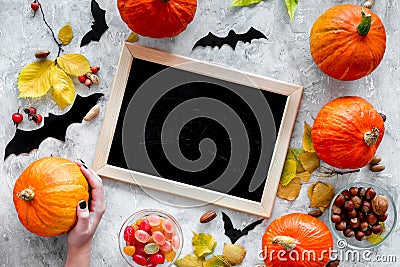 Preparing for halloween. Black desk for notes among pumpkins and bats on grey background top view mockup Stock Photo