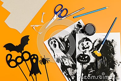 Preparing for Halloween. Handmade crafts. Top view of paper decorations for Halloween party on orange background. Stock Photo