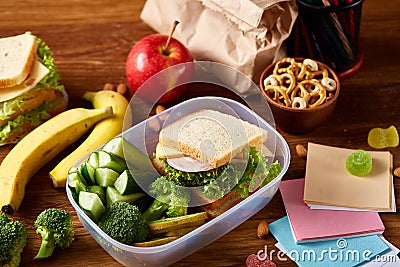 Preparing ham sandwiches for scool lunchbox on wooden background, close up. Stock Photo