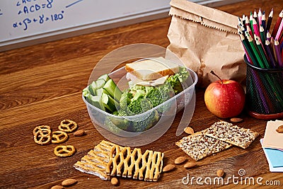 Preparing ham sandwiches for school lunchbox on wooden background, close up. Stock Photo