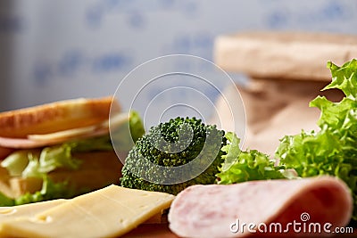 Preparing ham sandwiches for scool lunchbox on wooden background, close up. Stock Photo
