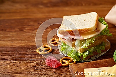 Preparing ham sandwiches for scool lunchbox on wooden background, close up. Stock Photo