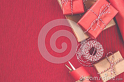 Preparing for the holiday - gift wrapping in red and beige wrapping paper Stock Photo