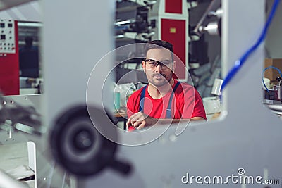 Preparing machine for printing. Maintenance engineer repair modern industrial machine. Stock Photo