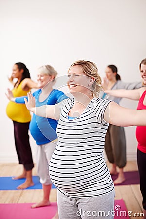 Preparing our bodies for the challenges of motherhood. A multi-ethnic group of pregnant women doing exercises with their Stock Photo