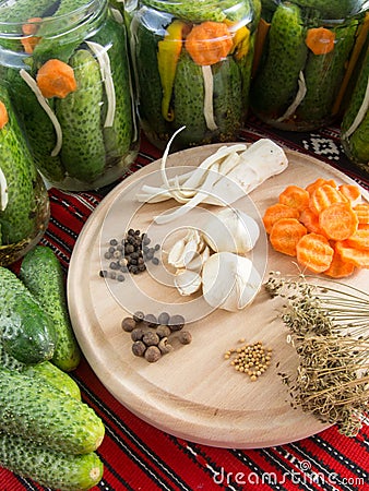 Preparing pickled cucumbers assorted with carrots, garlic, pepper, mustard seeds, celery, dill Stock Photo